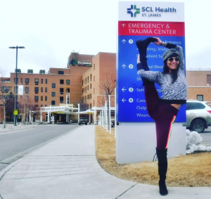 Holding leg by head in front of Hospital