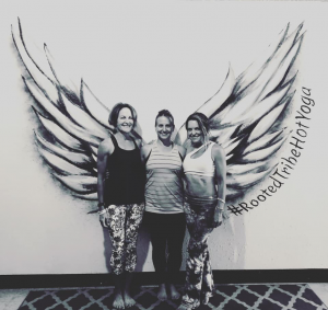 3 Ladies standing in front of wing mural