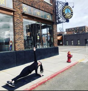 Forearm side plank in front of local business