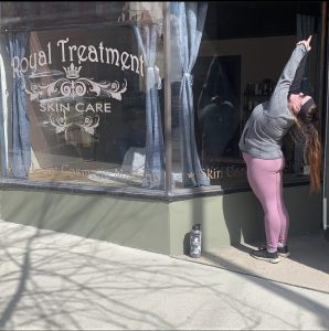 Standing backbend in front of local business